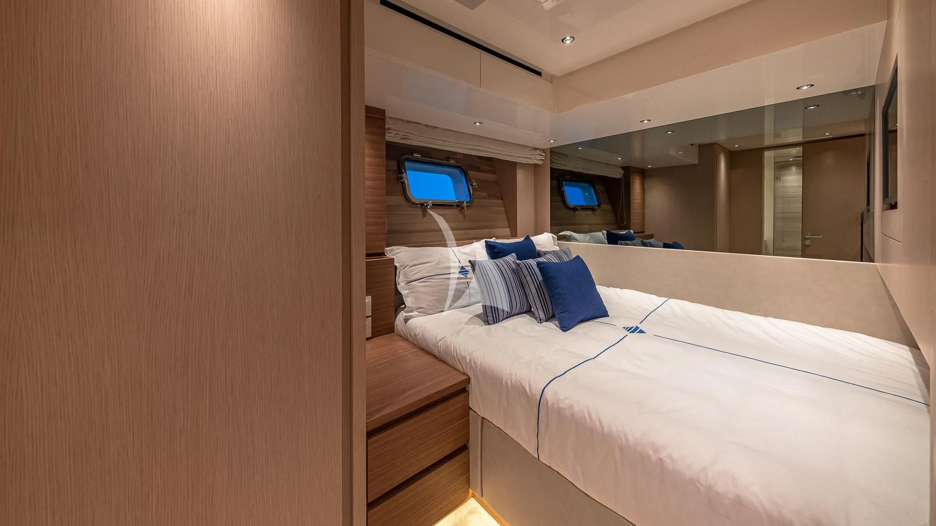 a room with a bed and a mirror aboard NO MATTER WHAT Yacht for Charter