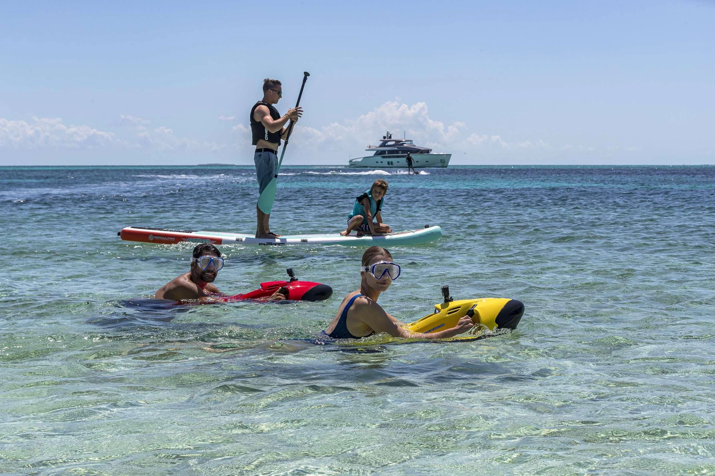 a group of people on surfboards in the ocean aboard NO MATTER WHAT Yacht for Charter