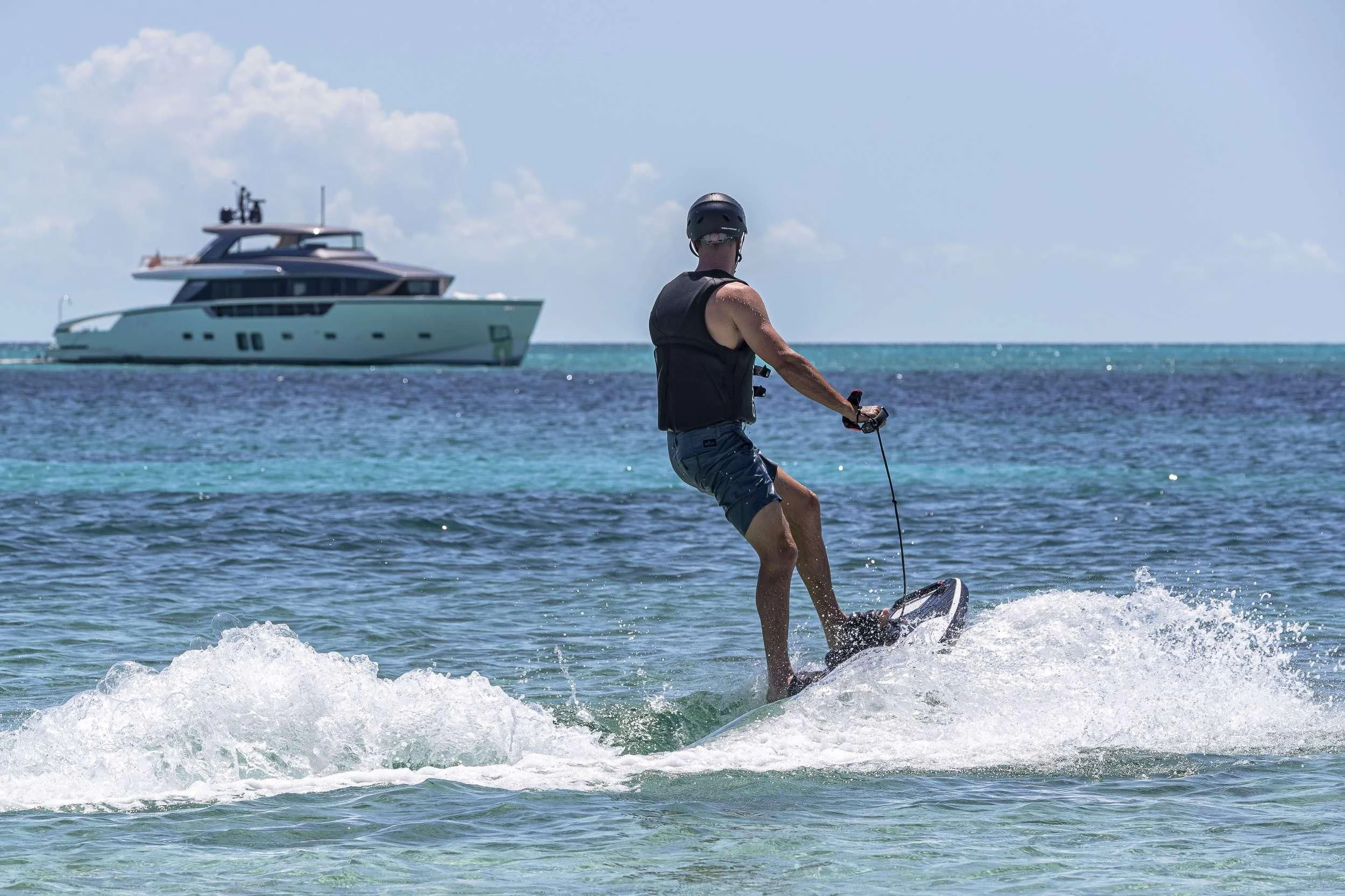a man is water skiing aboard NO MATTER WHAT Yacht for Charter