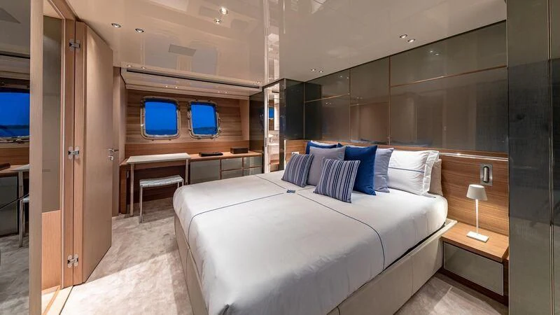 a room with a bed and a desk aboard NO MATTER WHAT Yacht for Charter