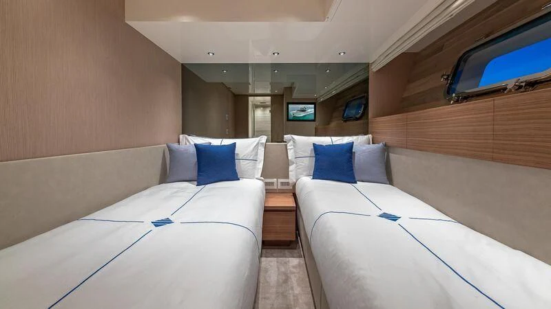 a room with beds and a tv aboard NO MATTER WHAT Yacht for Charter