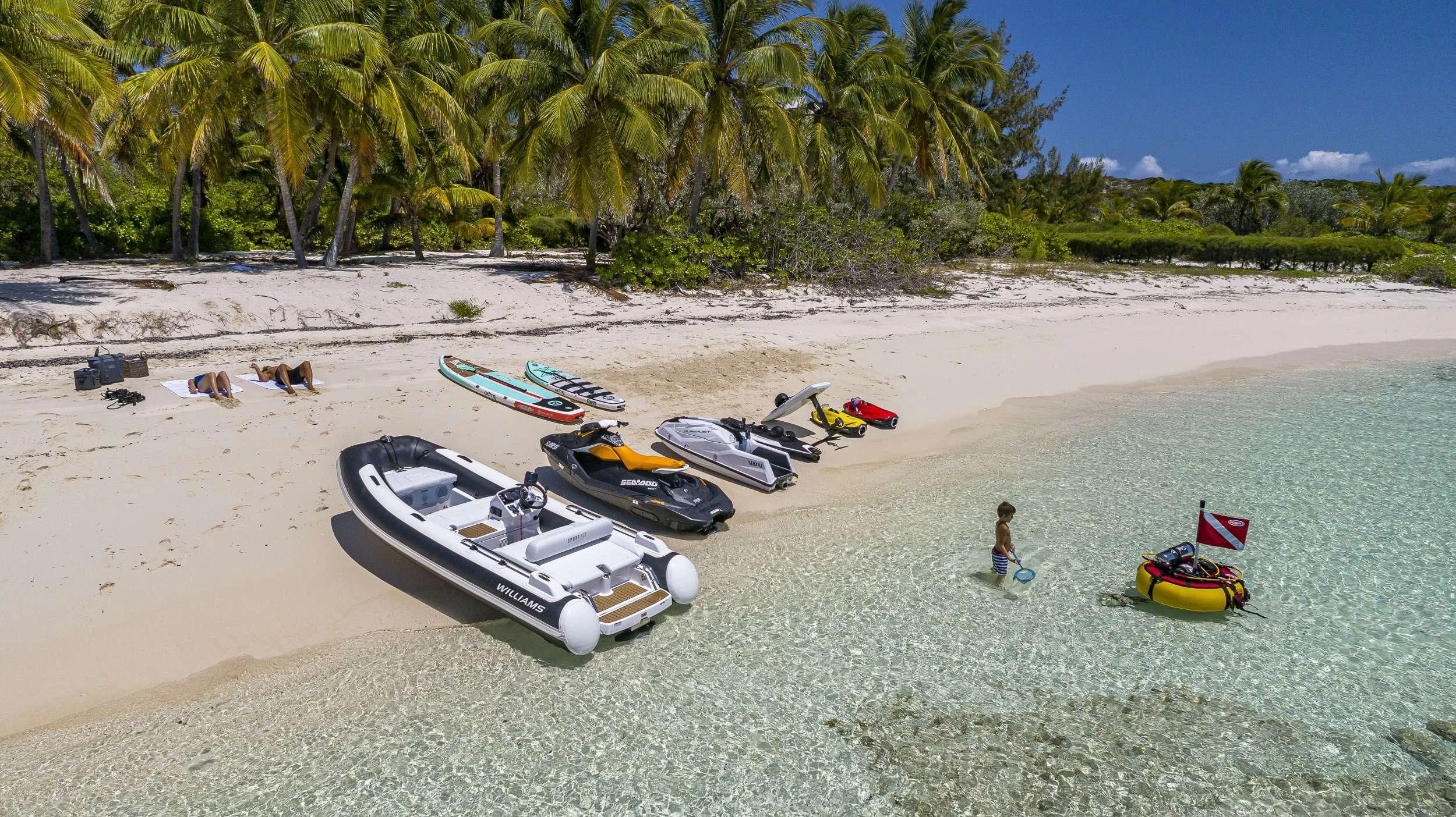 a group of boats on a beach aboard NO MATTER WHAT Yacht for Charter