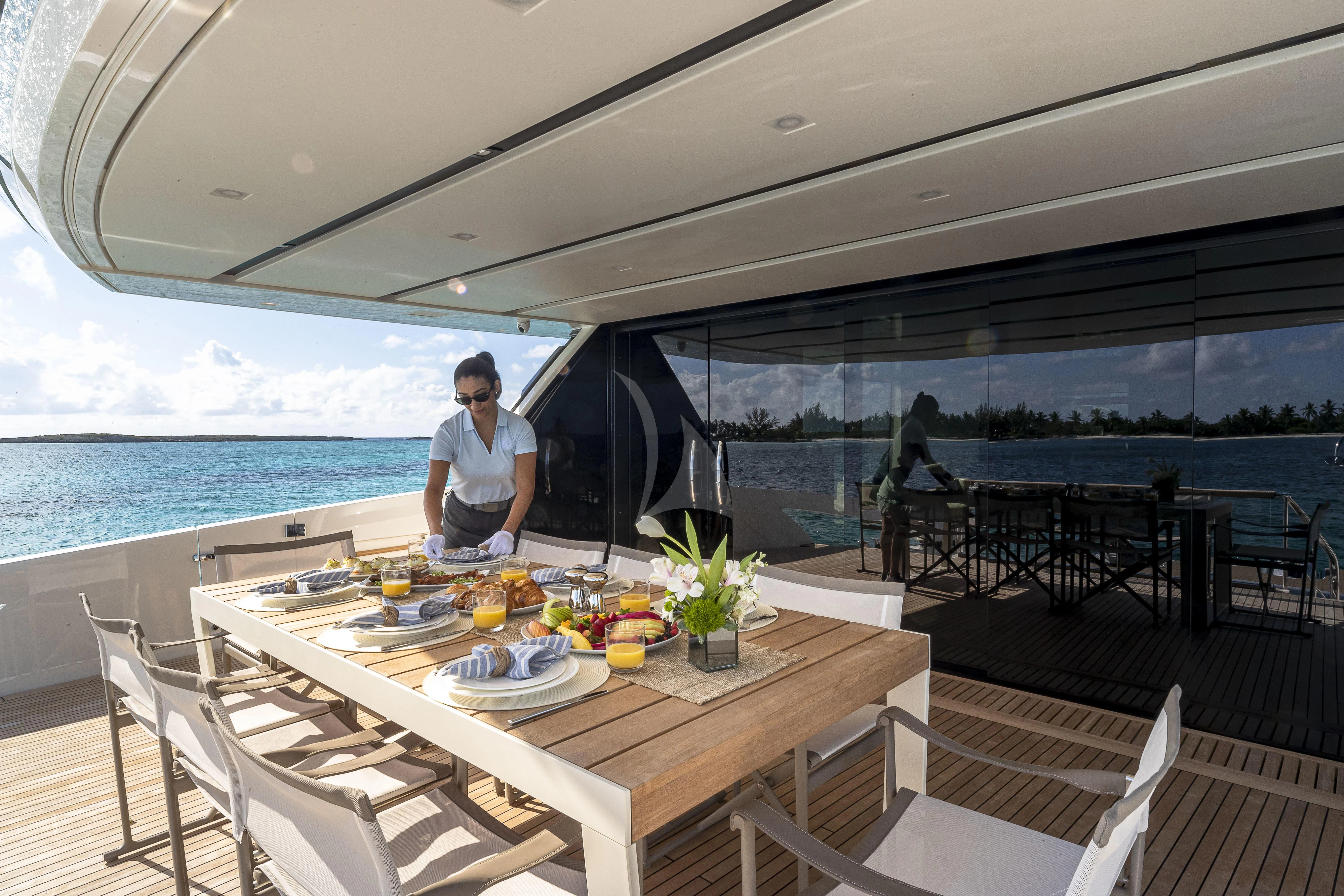 a person sitting at a table outside aboard NO MATTER WHAT Yacht for Charter