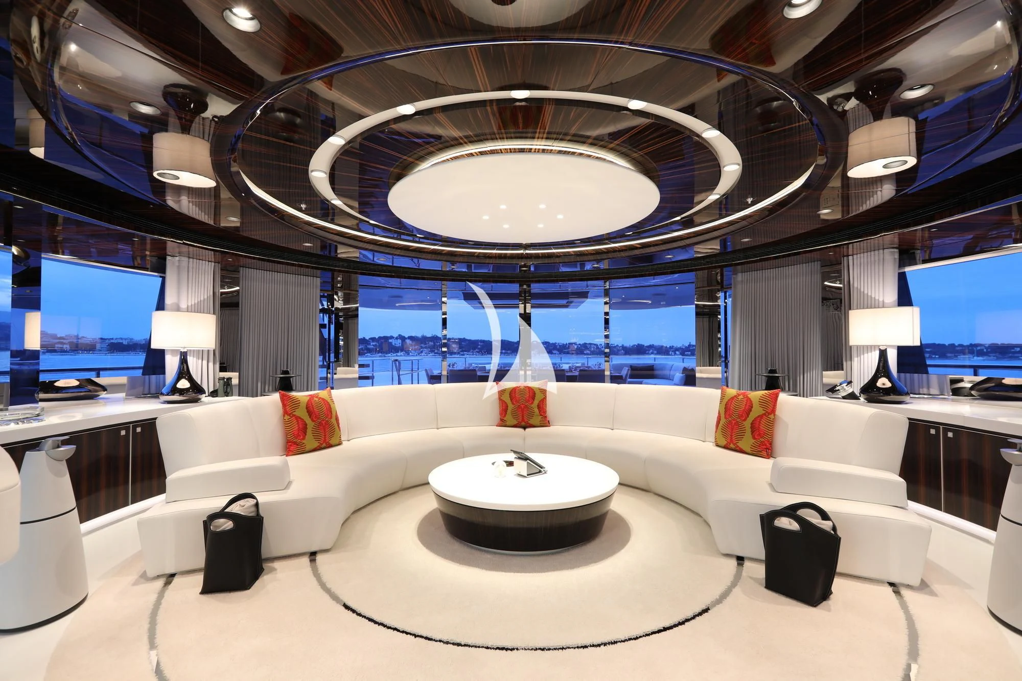 a large room with a large white couch and a large chandelier aboard PEARL Yacht for Sale