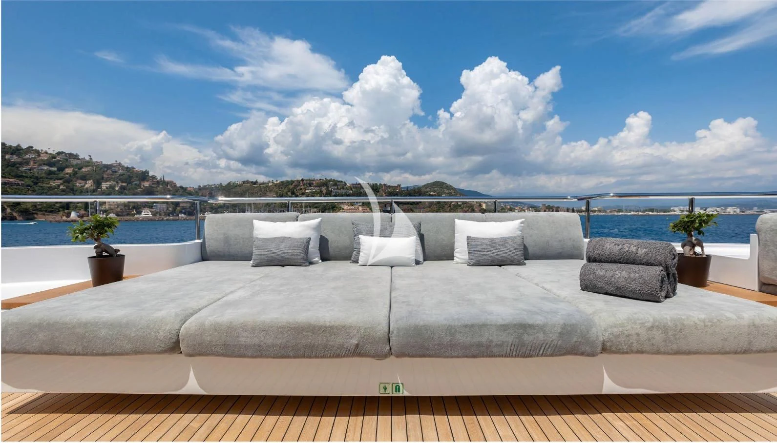 a large bed with a large body of water in the background aboard PEARL Yacht for Sale