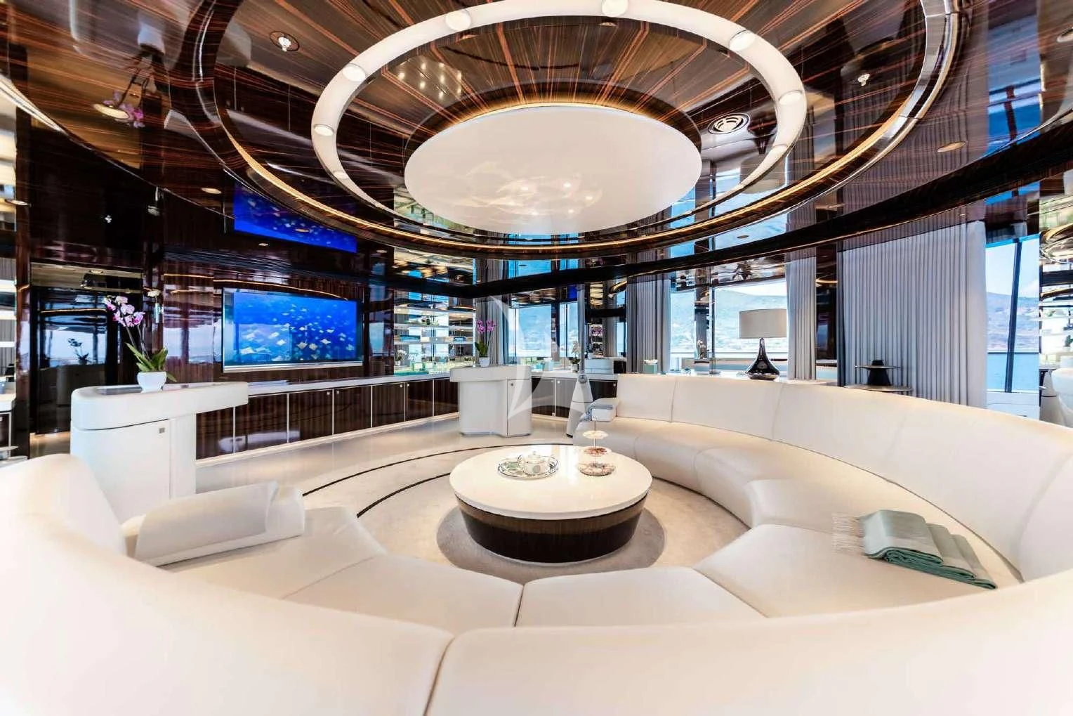 a large room with a large chandelier and a round table aboard PEARL Yacht for Sale