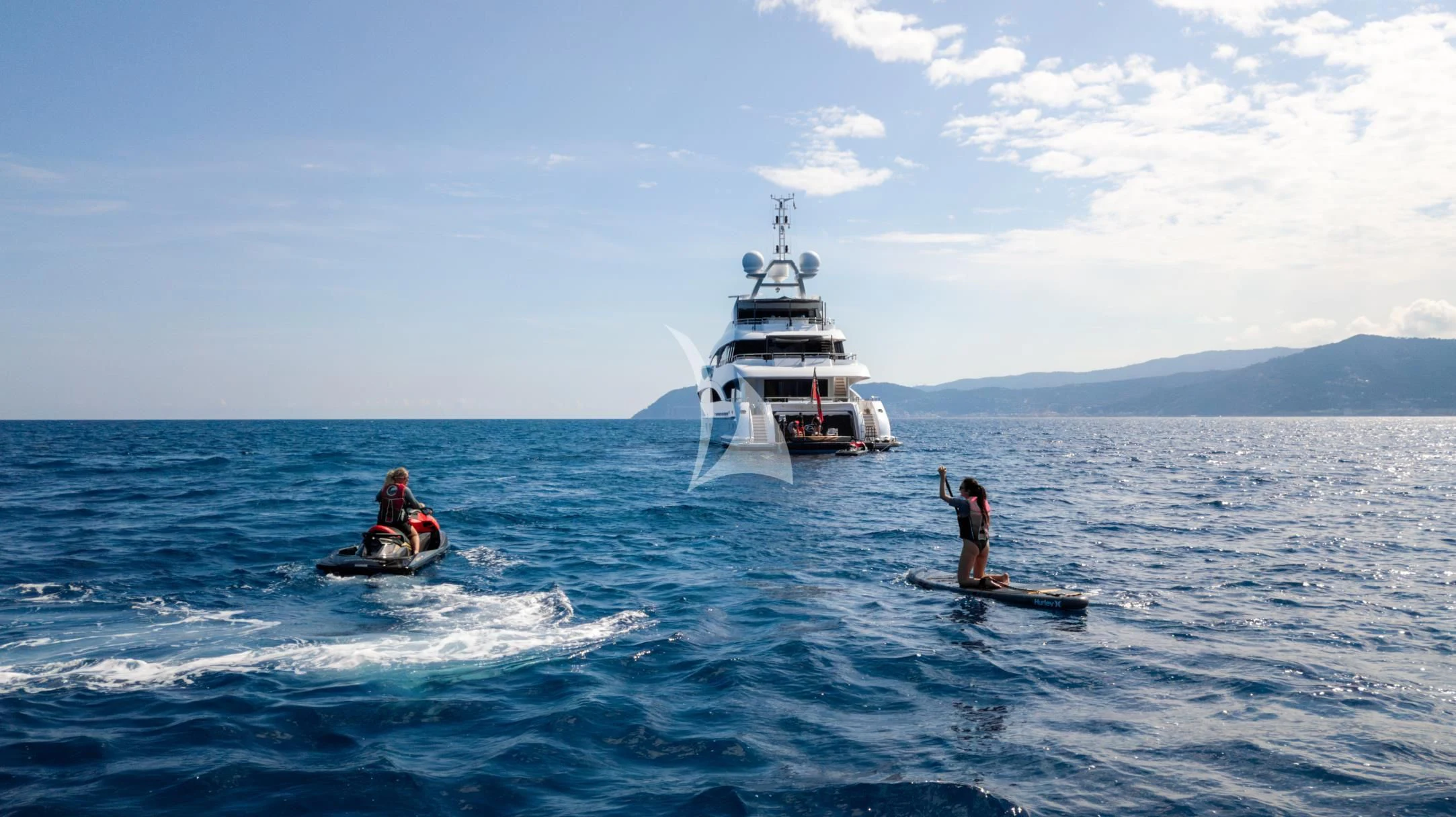 a boat and a couple people on the water aboard PEARL Yacht for Sale