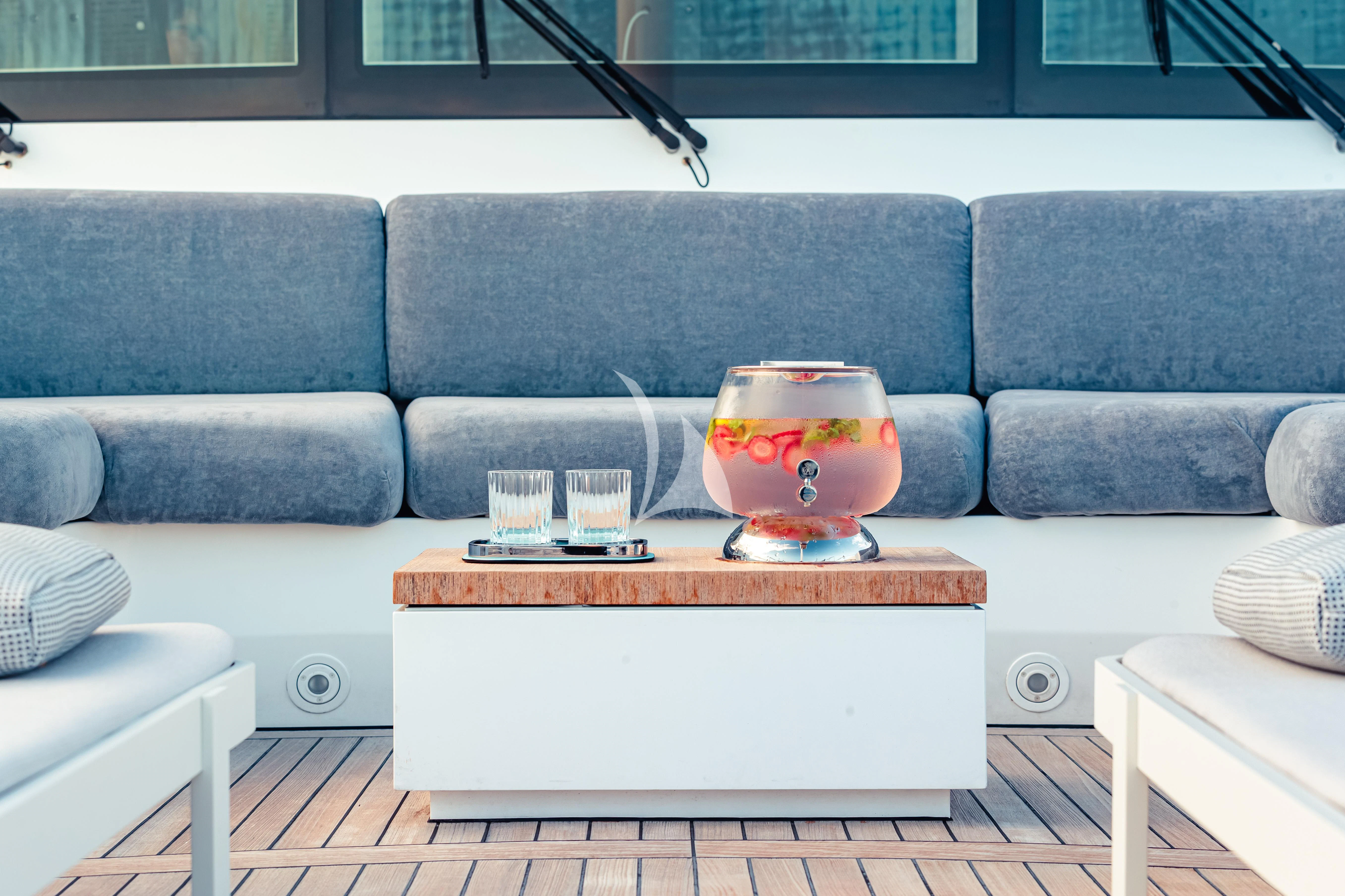 a coffee table on a couch aboard PEARL Yacht for Sale