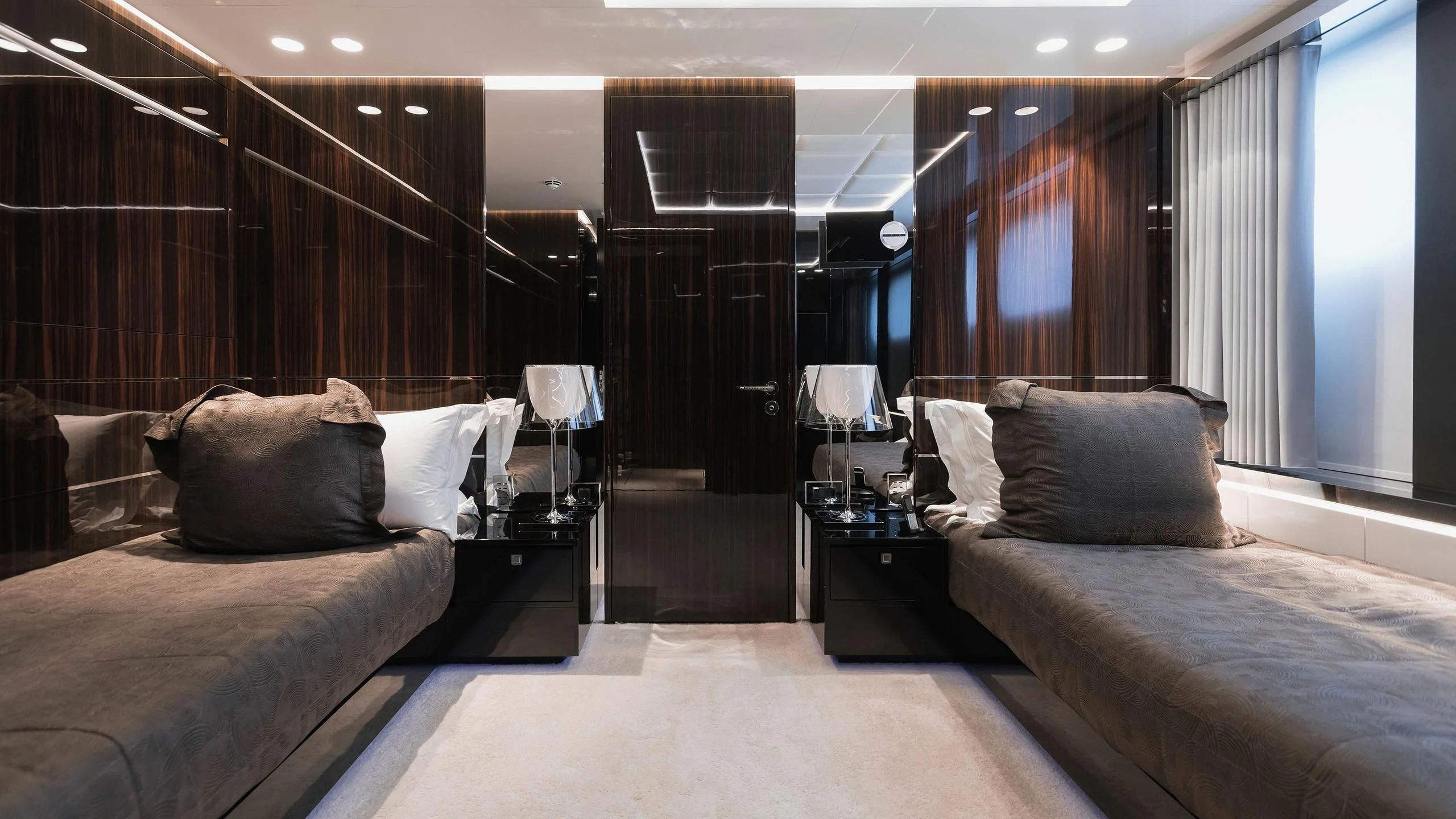 a room with beds and a window aboard PEARL Yacht for Sale