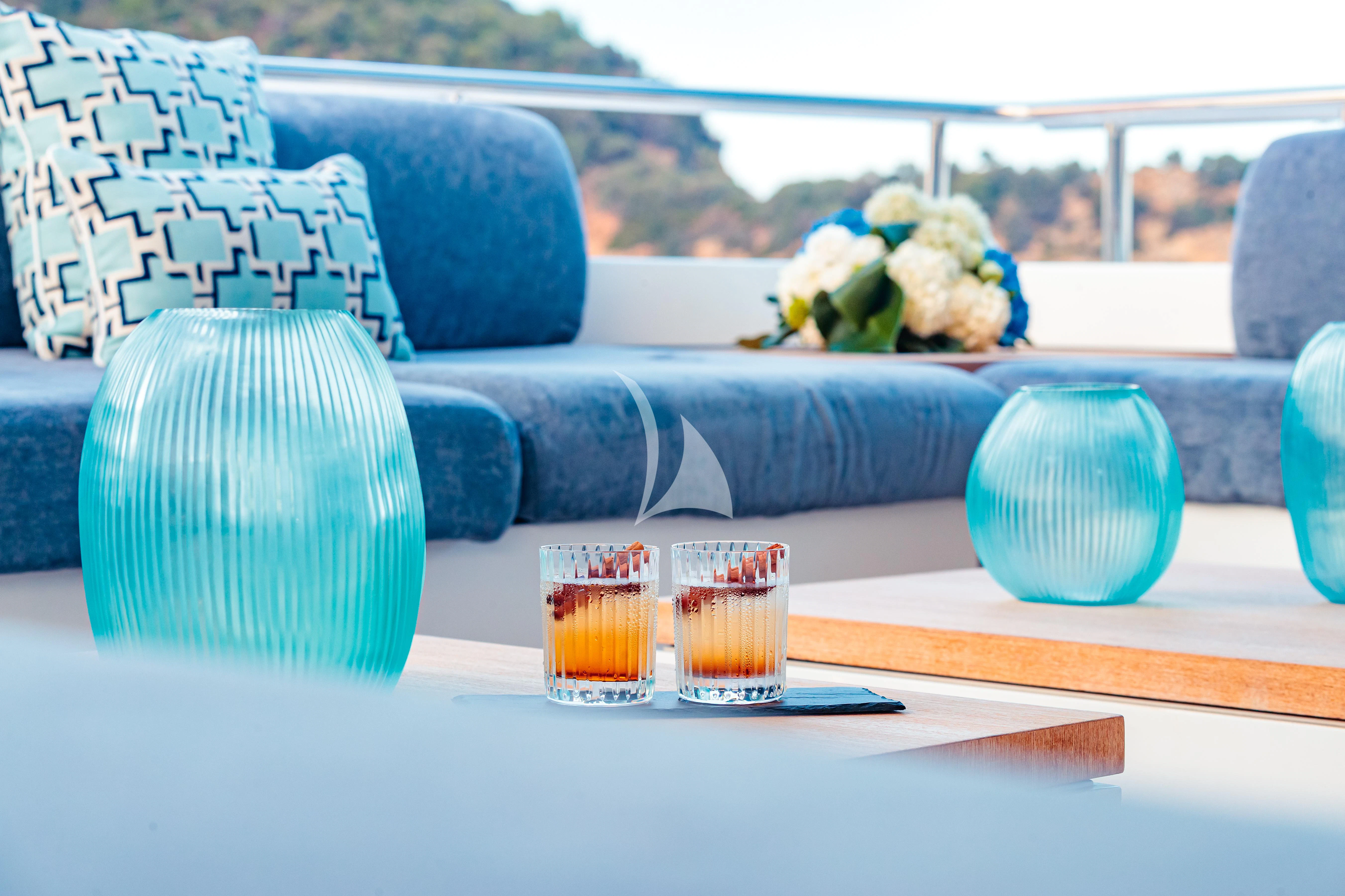 a table with glasses and a vase aboard PEARL Yacht for Sale
