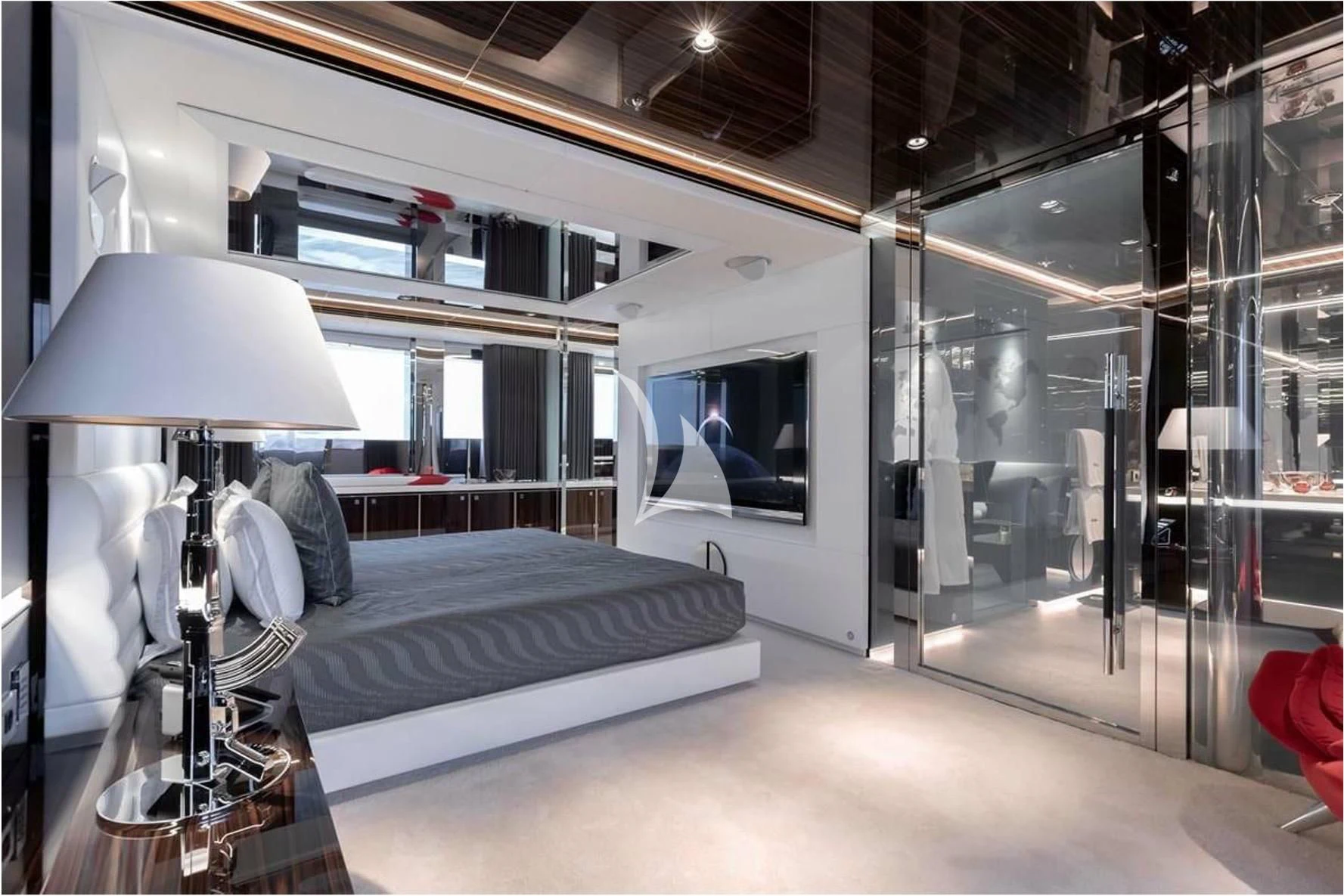a room with a bed and a lamp aboard PEARL Yacht for Sale