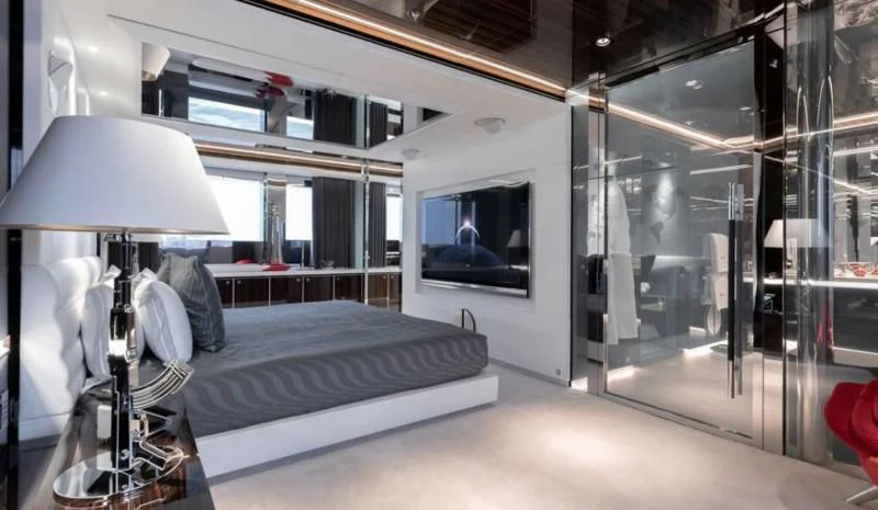 a room with a bed and a lamp aboard PEARL Yacht for Sale