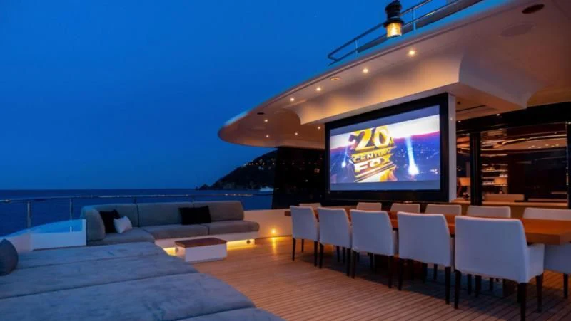 a large lounge area with a large screen and a large television aboard PEARL Yacht for Sale