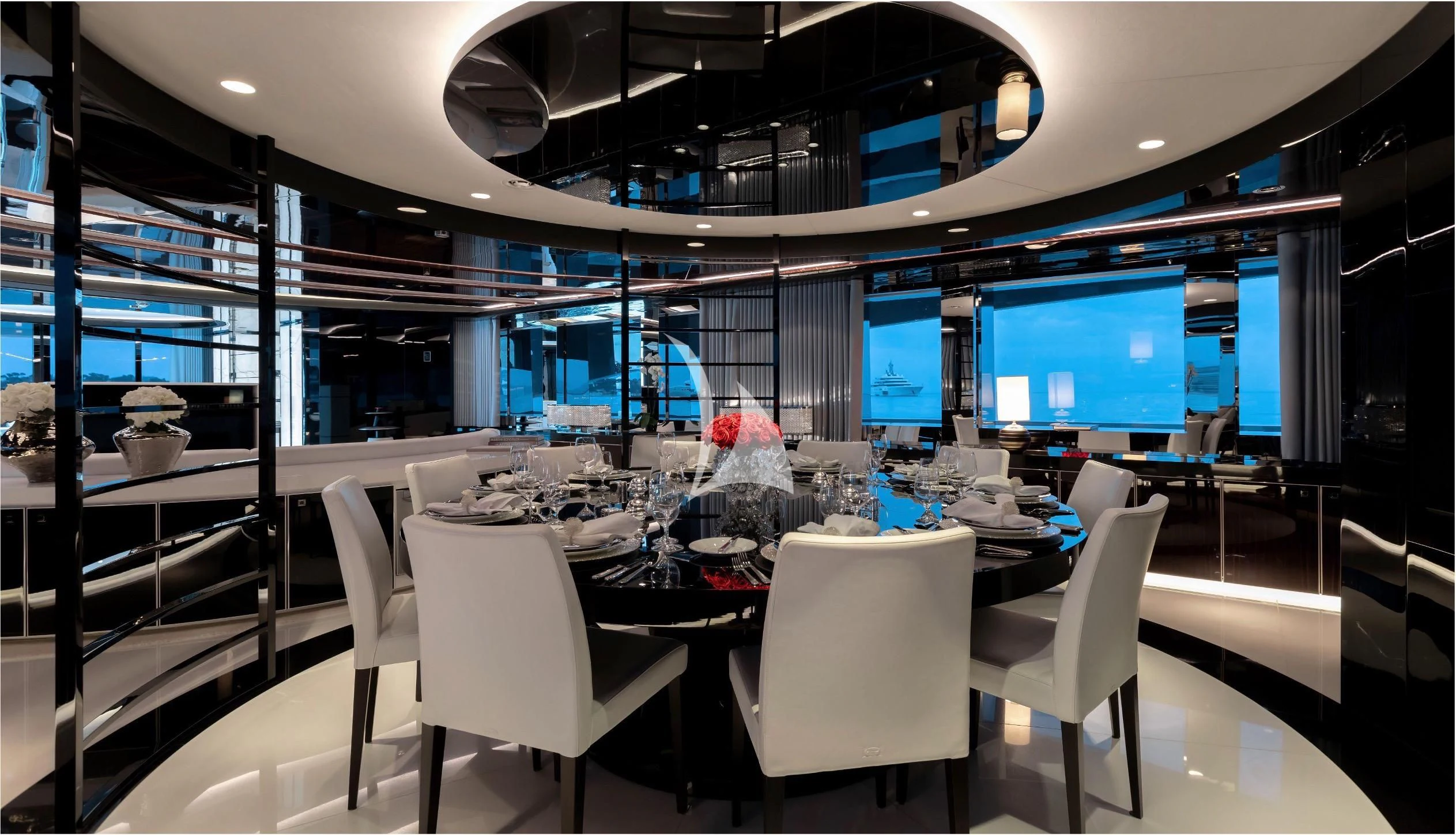 a room with a table chairs and a tv aboard PEARL Yacht for Sale