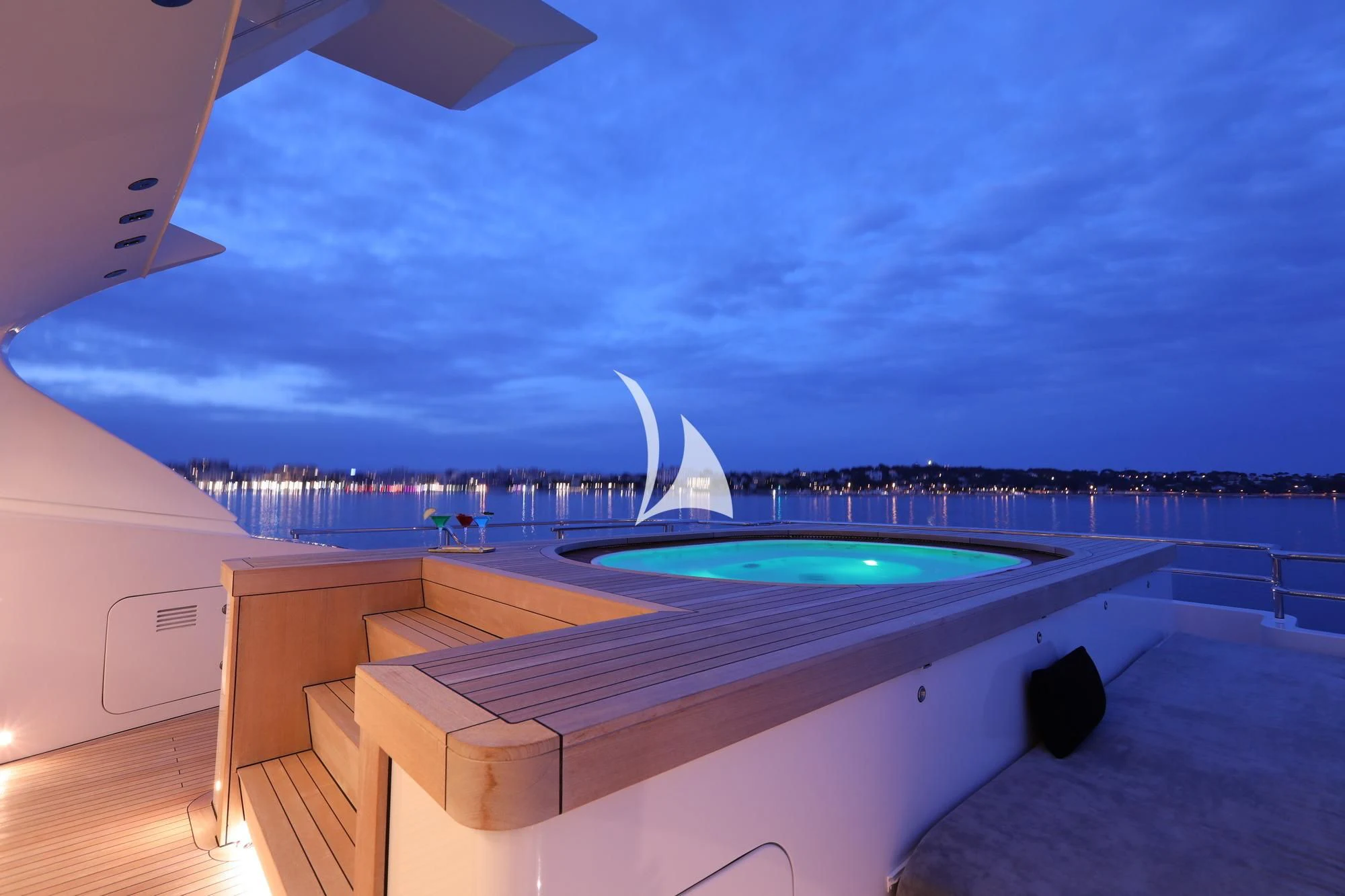 a pool with a large building in the background aboard PEARL Yacht for Sale