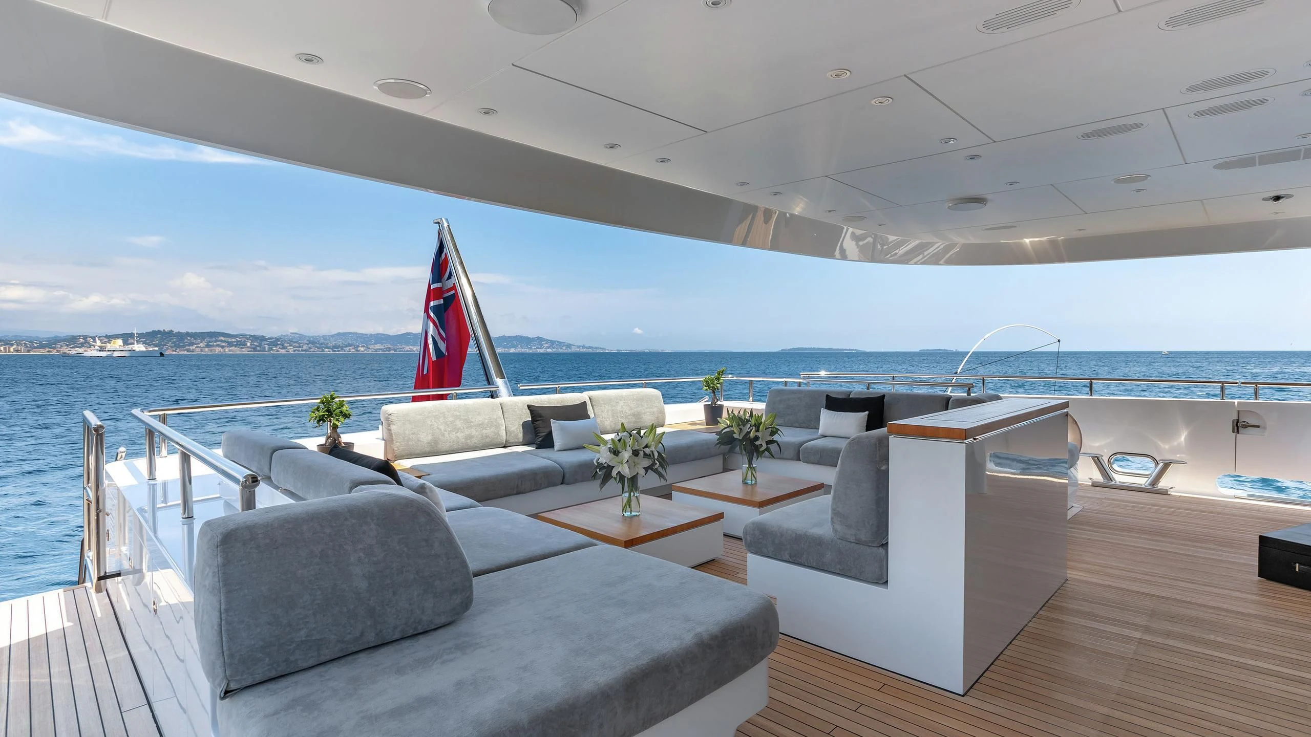 a room with a couch and a flag on the wall aboard PEARL Yacht for Sale