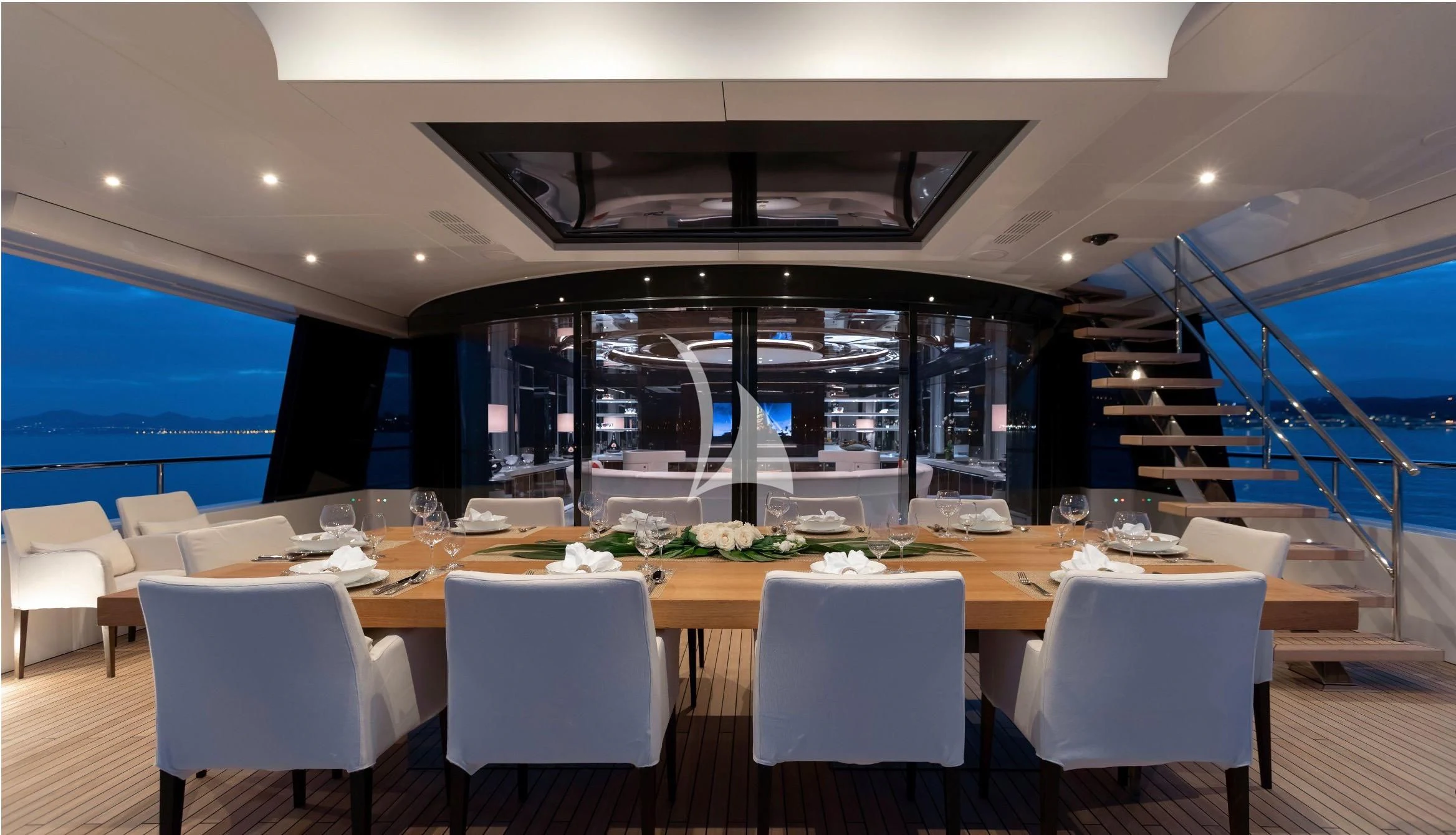 a large dining room with white chairs aboard PEARL Yacht for Sale