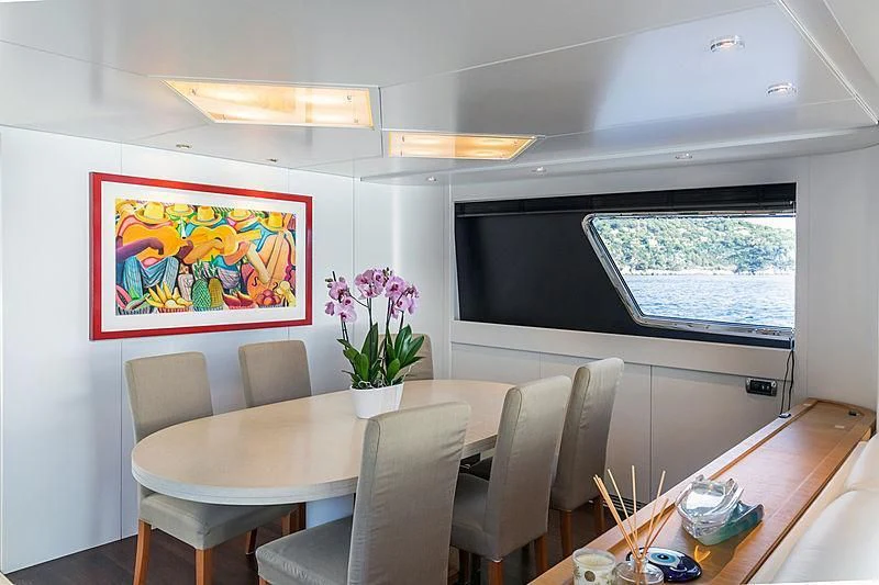 a room with a table chairs and a television aboard GAVEAU Yacht for Sale