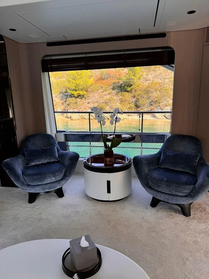 a room with a table chairs and a plant in a pot aboard BETTY Yacht for Sale