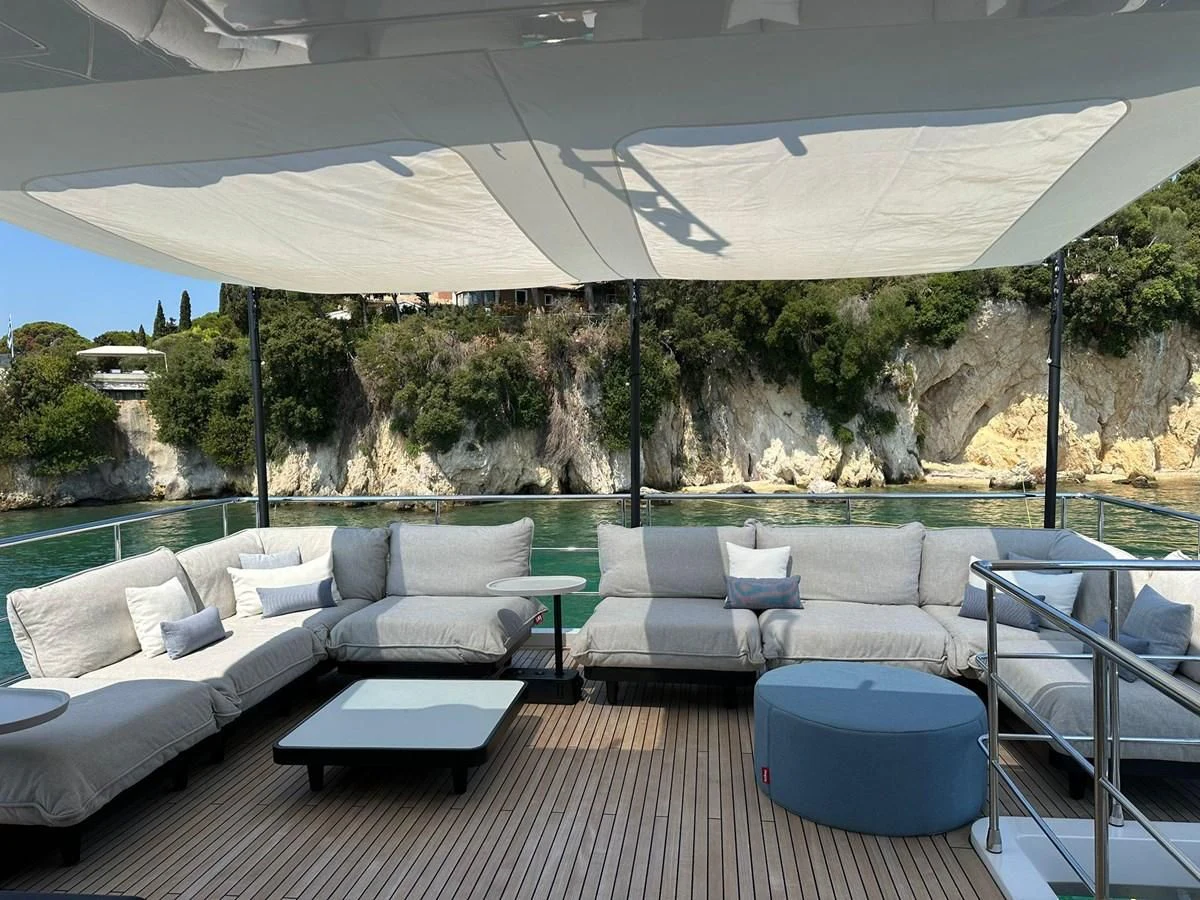 a large white couch and a table under a large umbrella aboard BETTY Yacht for Sale