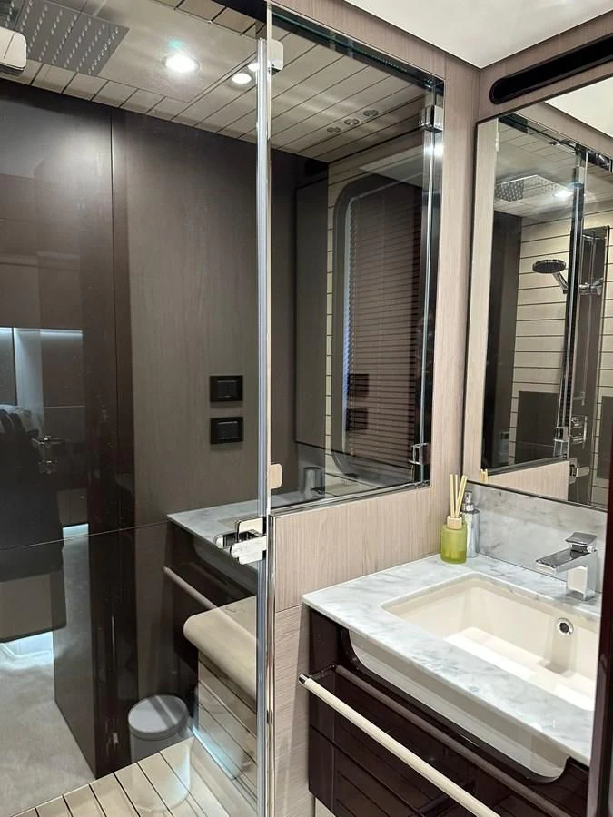 a bathroom with a glass shower aboard BETTY Yacht for Sale