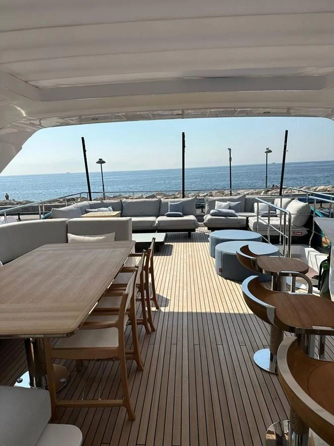a deck with tables and chairs aboard BETTY Yacht for Sale