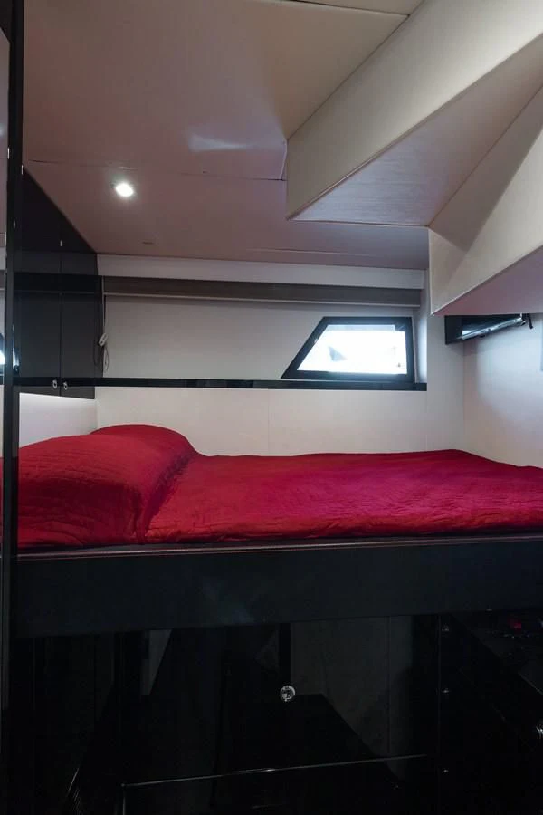 a bed with red sheets aboard ASHLEY Yacht for Sale