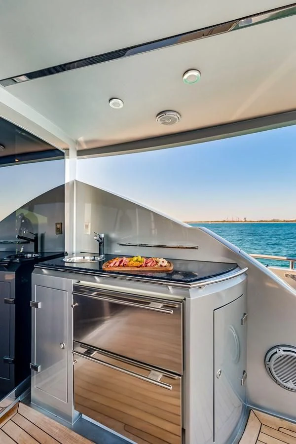 a large kitchen with a pizza on the oven aboard ASHLEY Yacht for Sale