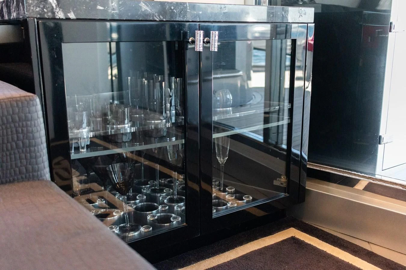 a large black cabinet with glasses aboard ASHLEY Yacht for Sale