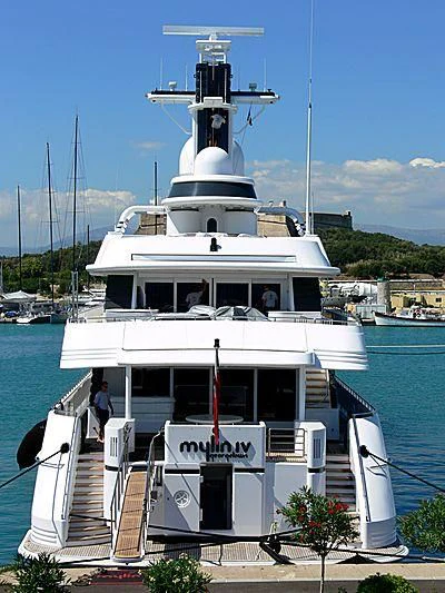 a boat with a deck and a dock with a dock and trees aboard MYLIN IV Yacht for Sale