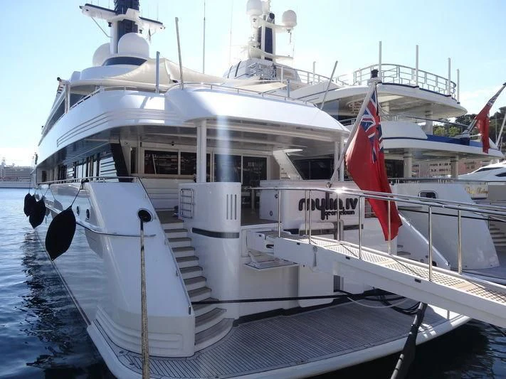 a large white boat with a flag on the front aboard MYLIN IV Yacht for Sale