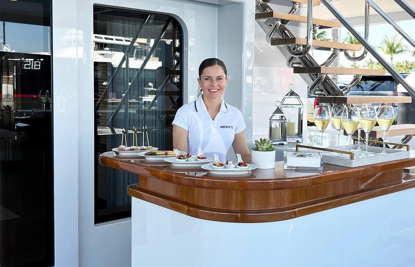 a man sitting at a table with food and drinks aboard SPORT Yacht for Sale
