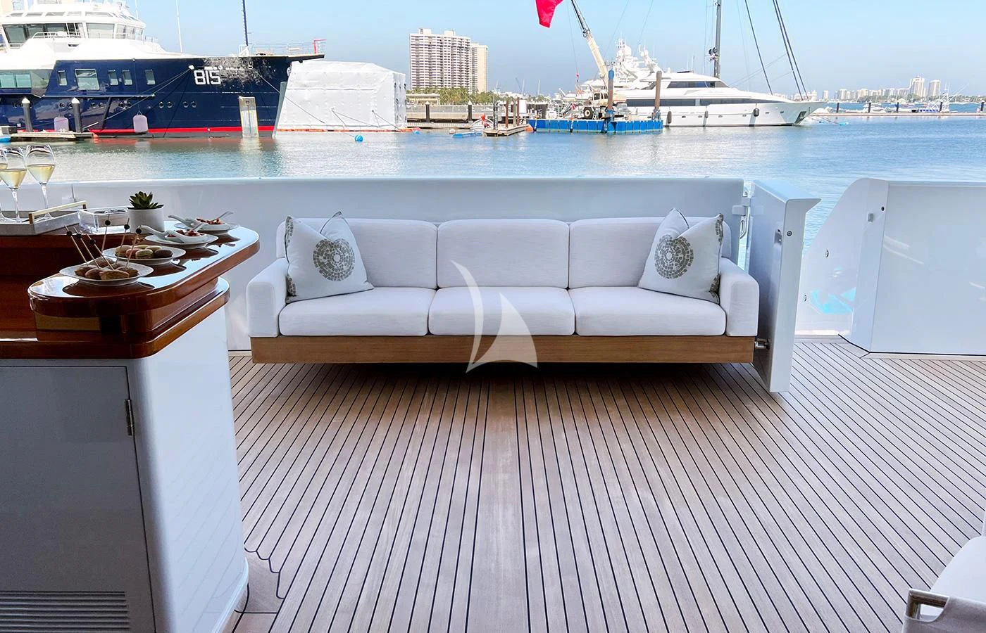 a white couch on a deck overlooking a body of water aboard SPORT Yacht for Sale
