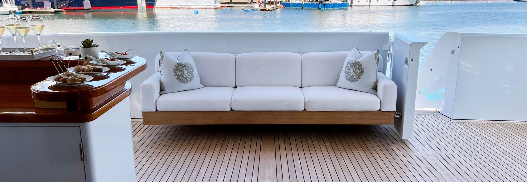 a white couch next to a pool aboard SPORT Yacht for Sale