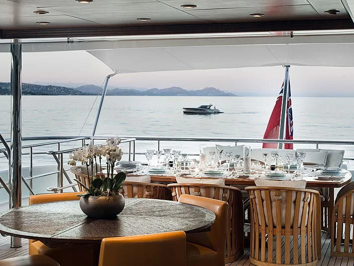 a restaurant with a large body of water in the background aboard SPORT Yacht for Sale