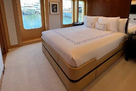 a bed with a white sheet aboard SPORT Yacht for Sale