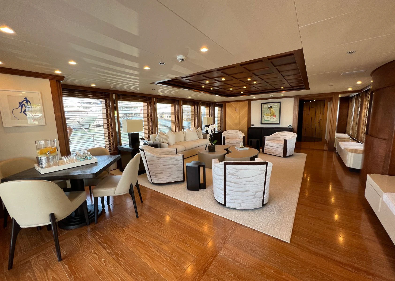 a large living room with a table and chairs aboard SPORT Yacht for Sale