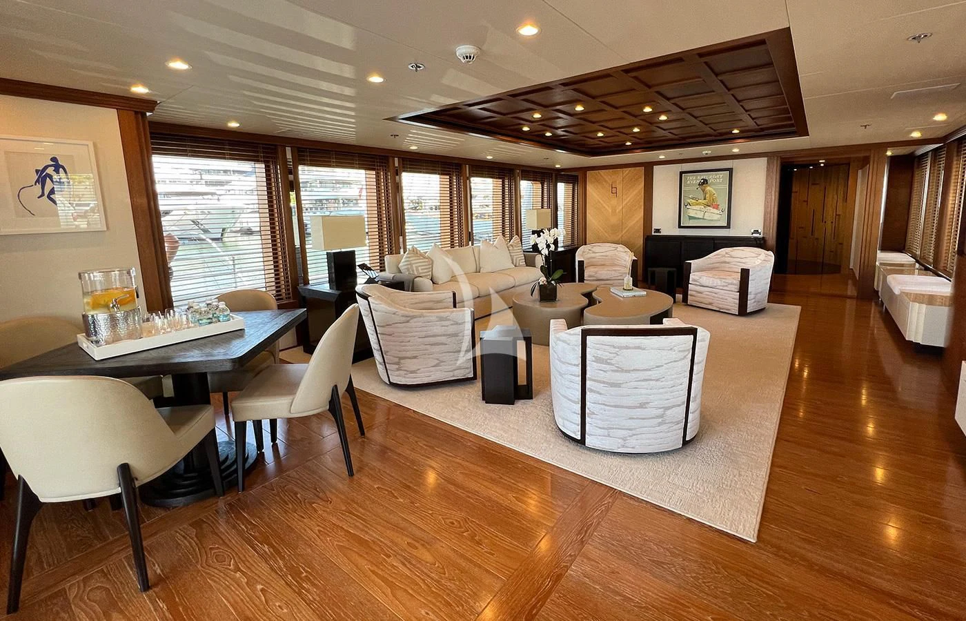 a room with tables and chairs aboard SPORT Yacht for Sale