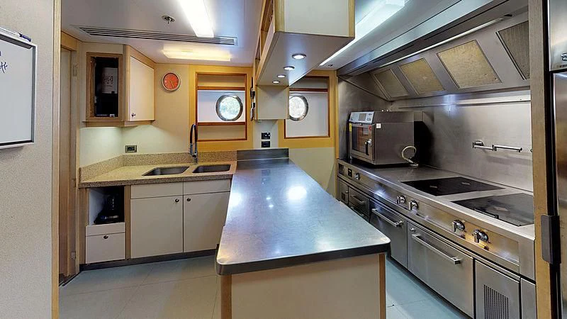 a kitchen with a large island aboard SPORT Yacht for Sale