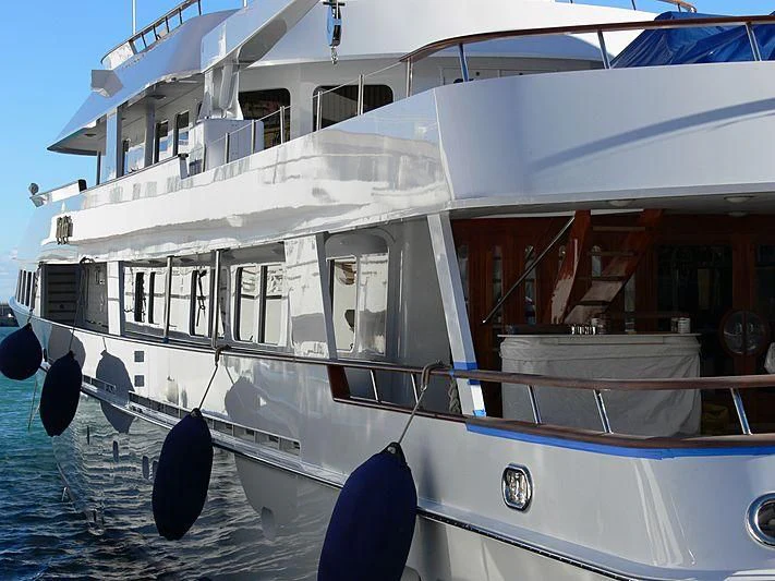 a large white boat with a blue and black stripe aboard RIO RITA Yacht for Sale
