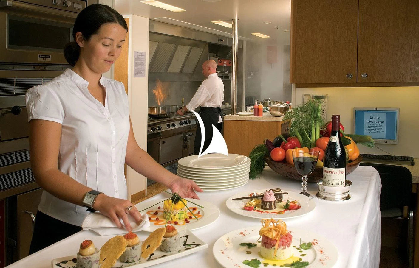 a woman preparing food in a kitchen aboard UTOPIA Yacht for Sale