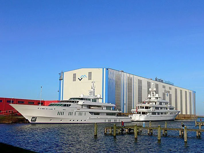a large cruise ship docked at a port aboard UTOPIA Yacht for Sale