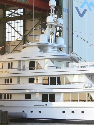 a large white boat in a large building aboard UTOPIA Yacht for Sale