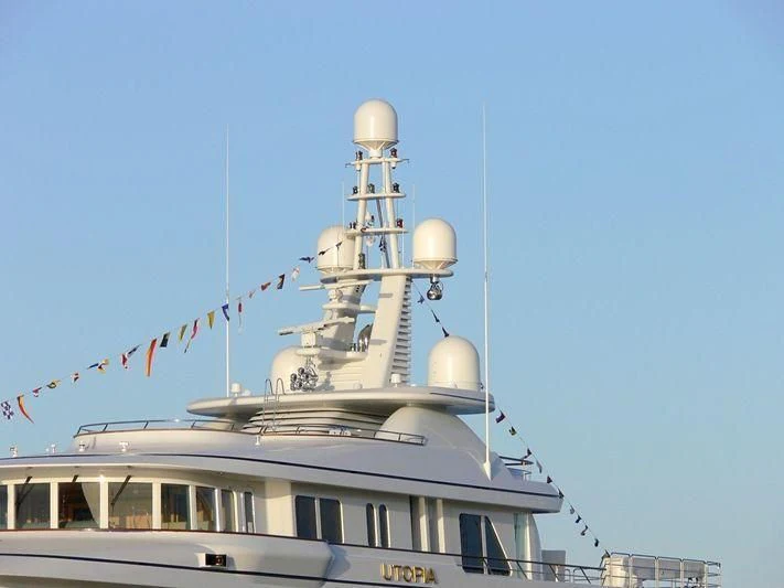 a large white ship with flags aboard UTOPIA Yacht for Sale