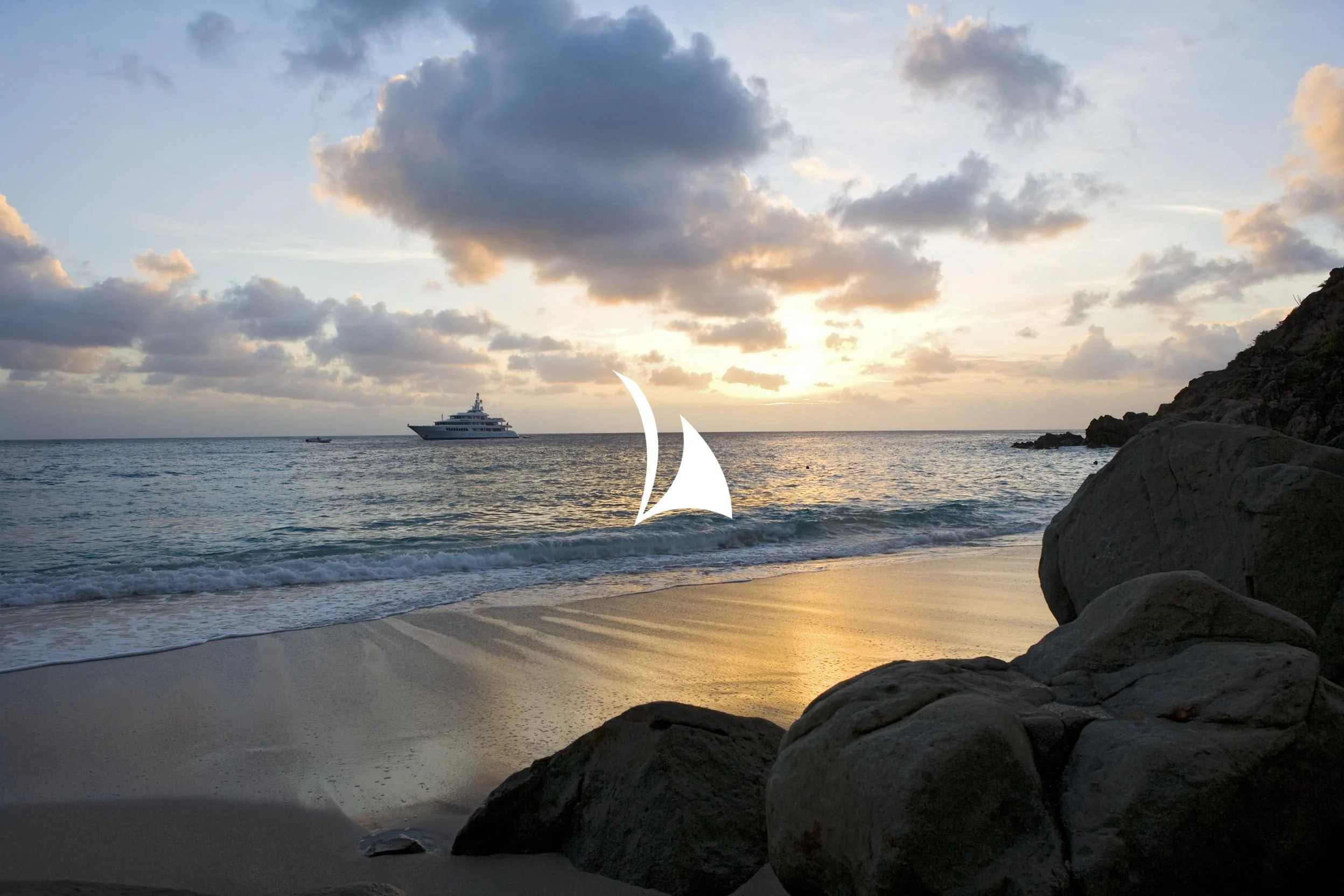 a body of water with rocks and a boat in the distance aboard UTOPIA Yacht for Sale