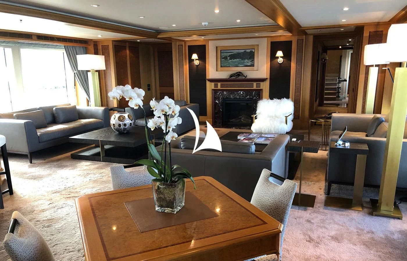 a living room with a fireplace aboard UTOPIA Yacht for Sale