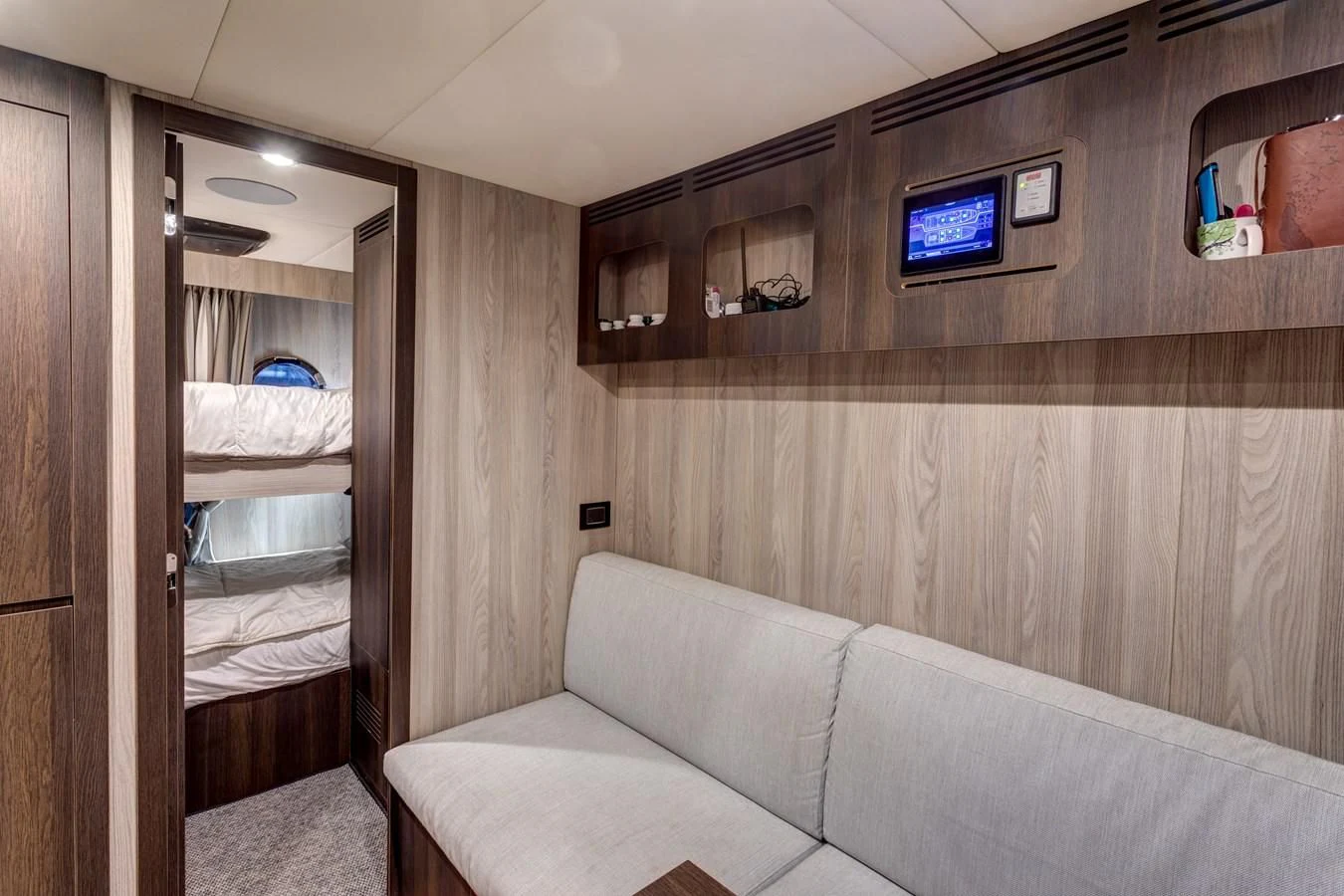 a room with a couch and a tv on the wall aboard CAPTAIN MORGAN II Yacht for Sale