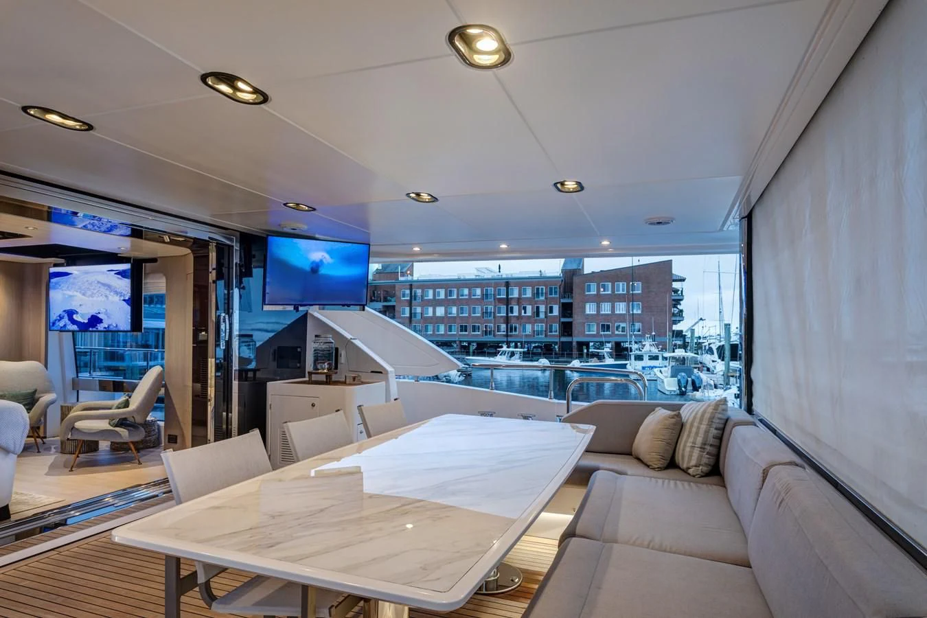 inside of a room with a couch and a table with a view of a city aboard CAPTAIN MORGAN II Yacht for Sale