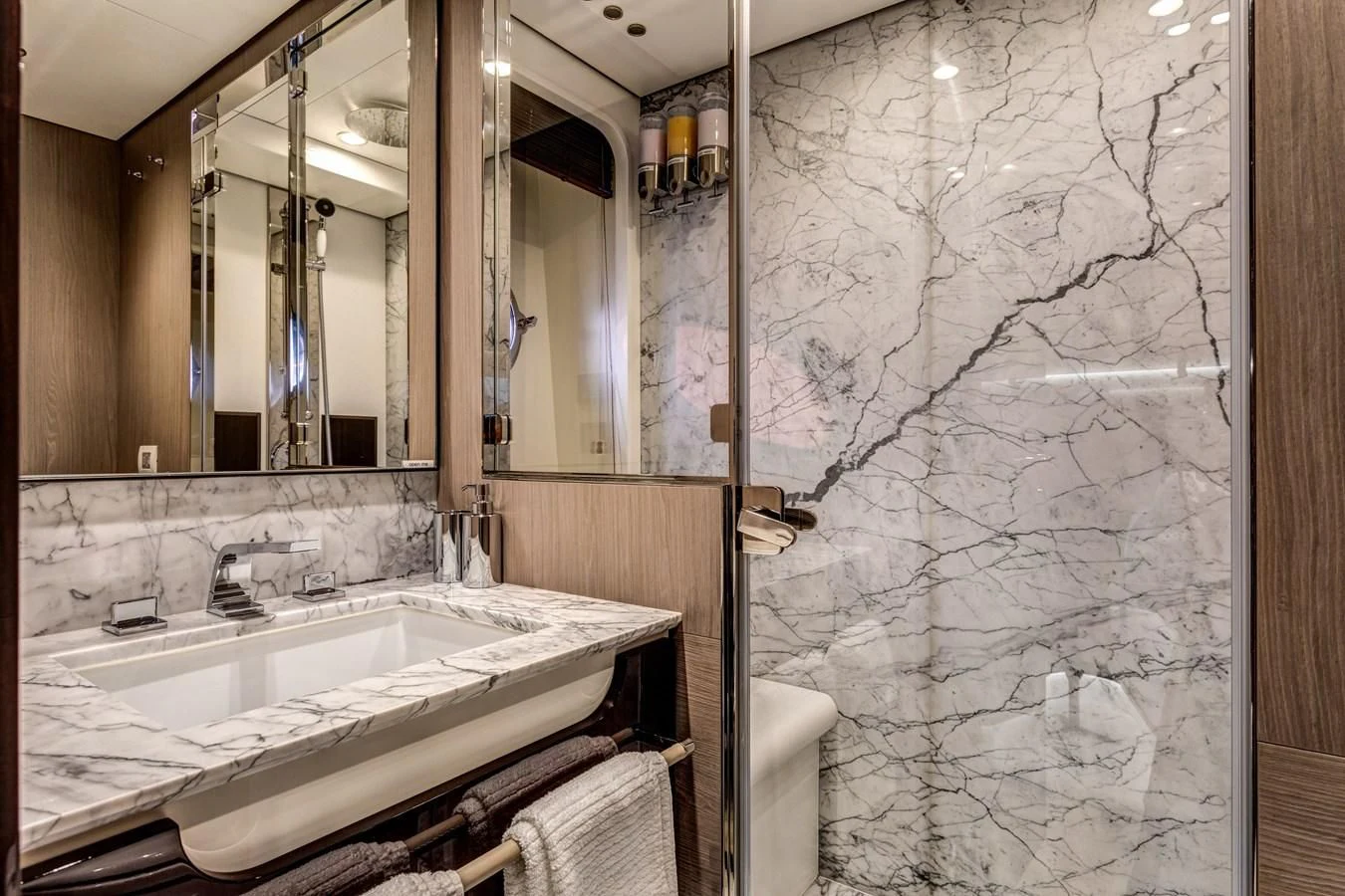 a bathroom with a large mirror aboard CAPTAIN MORGAN II Yacht for Sale