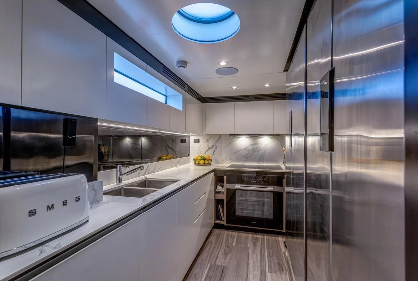 a kitchen with a glass wall aboard CAPTAIN MORGAN II Yacht for Sale